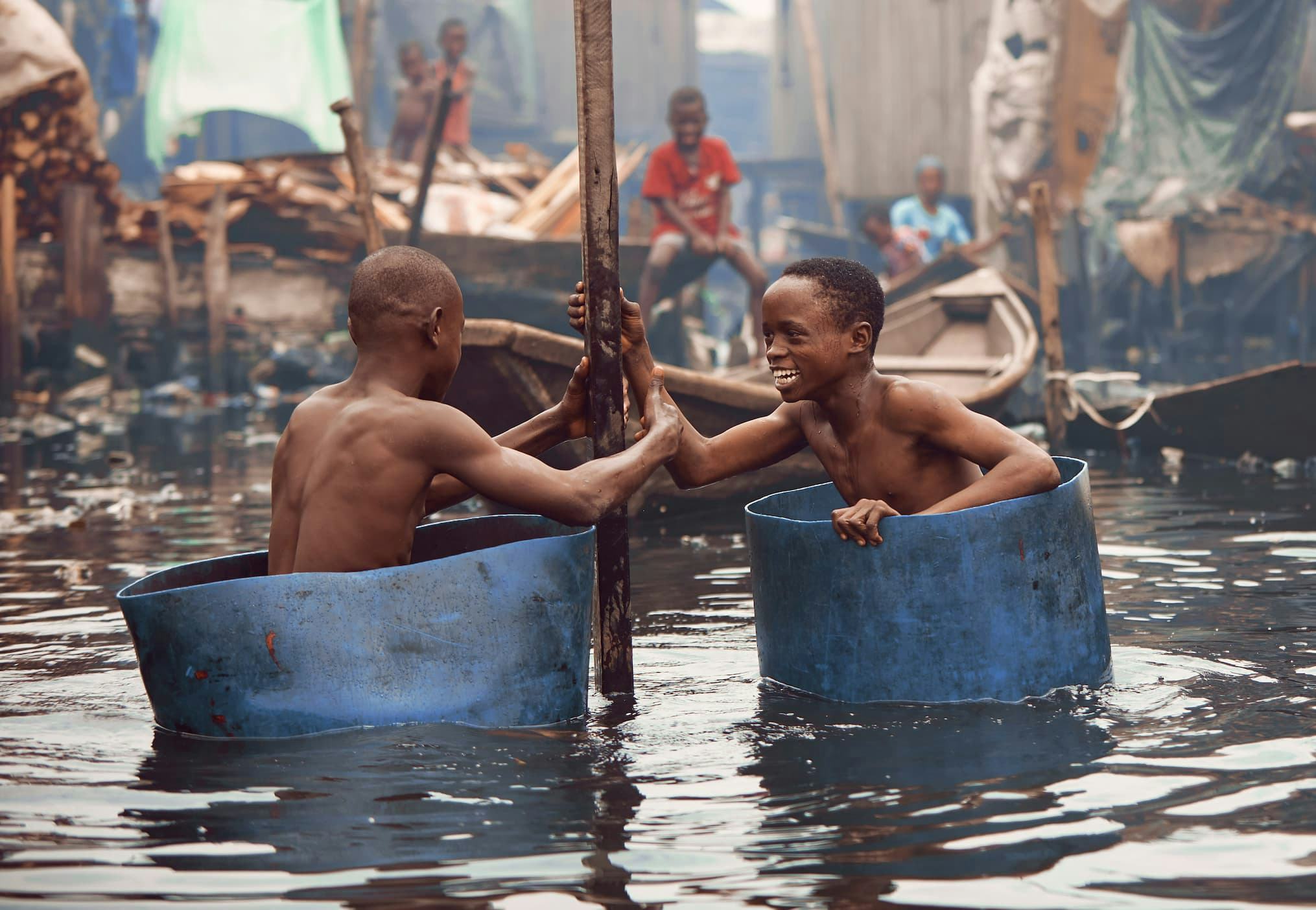 Echoes of laughter ring out over the water as the children of the Makoko community, play with their make shift boats